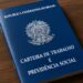 Carteira de Trabalho e Previdência Social brasileira sobre uma mesa de madeira.